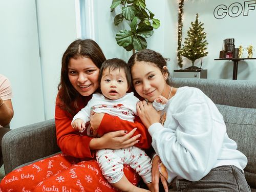 Two ladies carrying their brother at Turning Point Church.