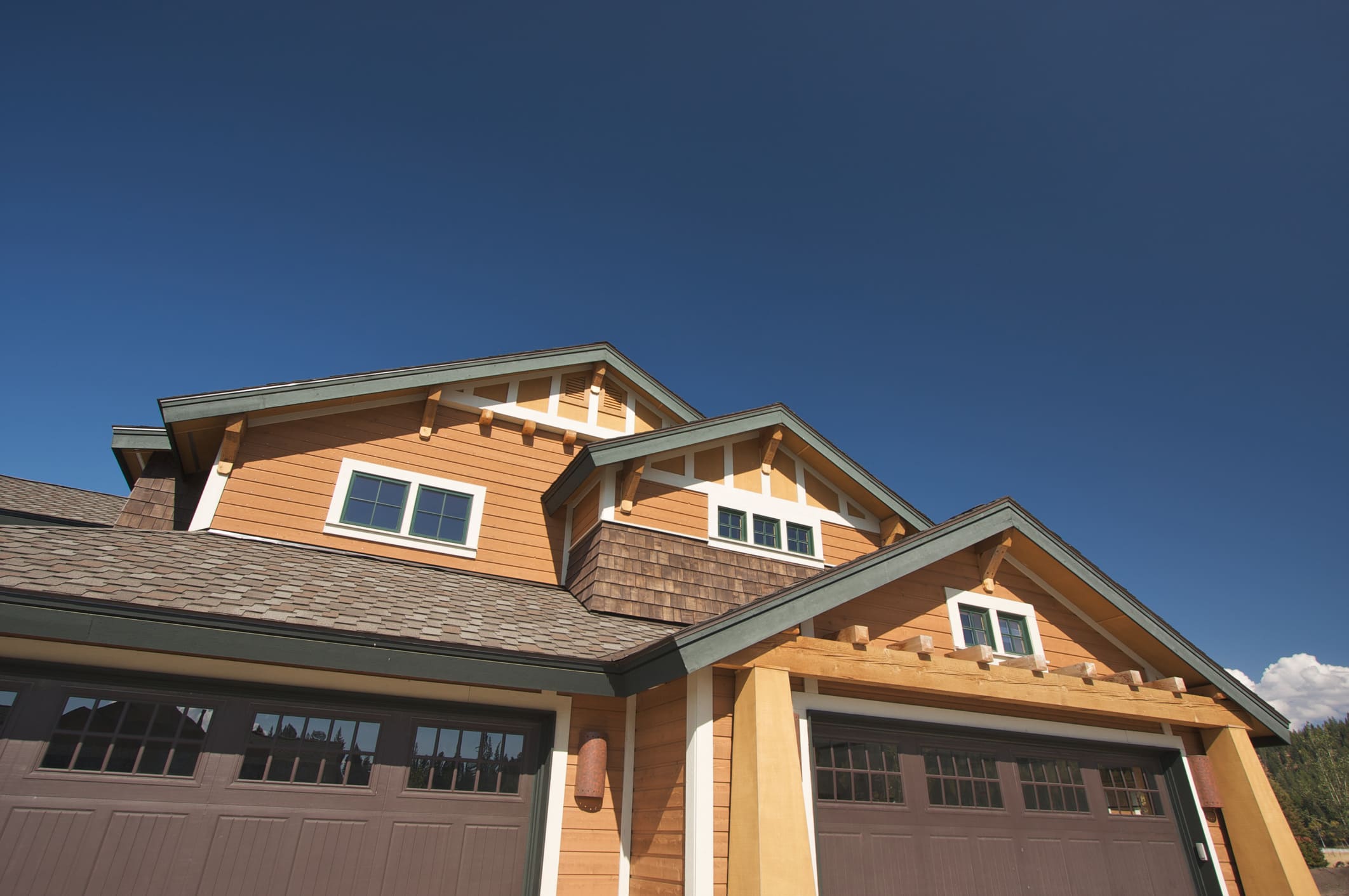 Craftsman-style home with orange siding, cedar accents and white trim.