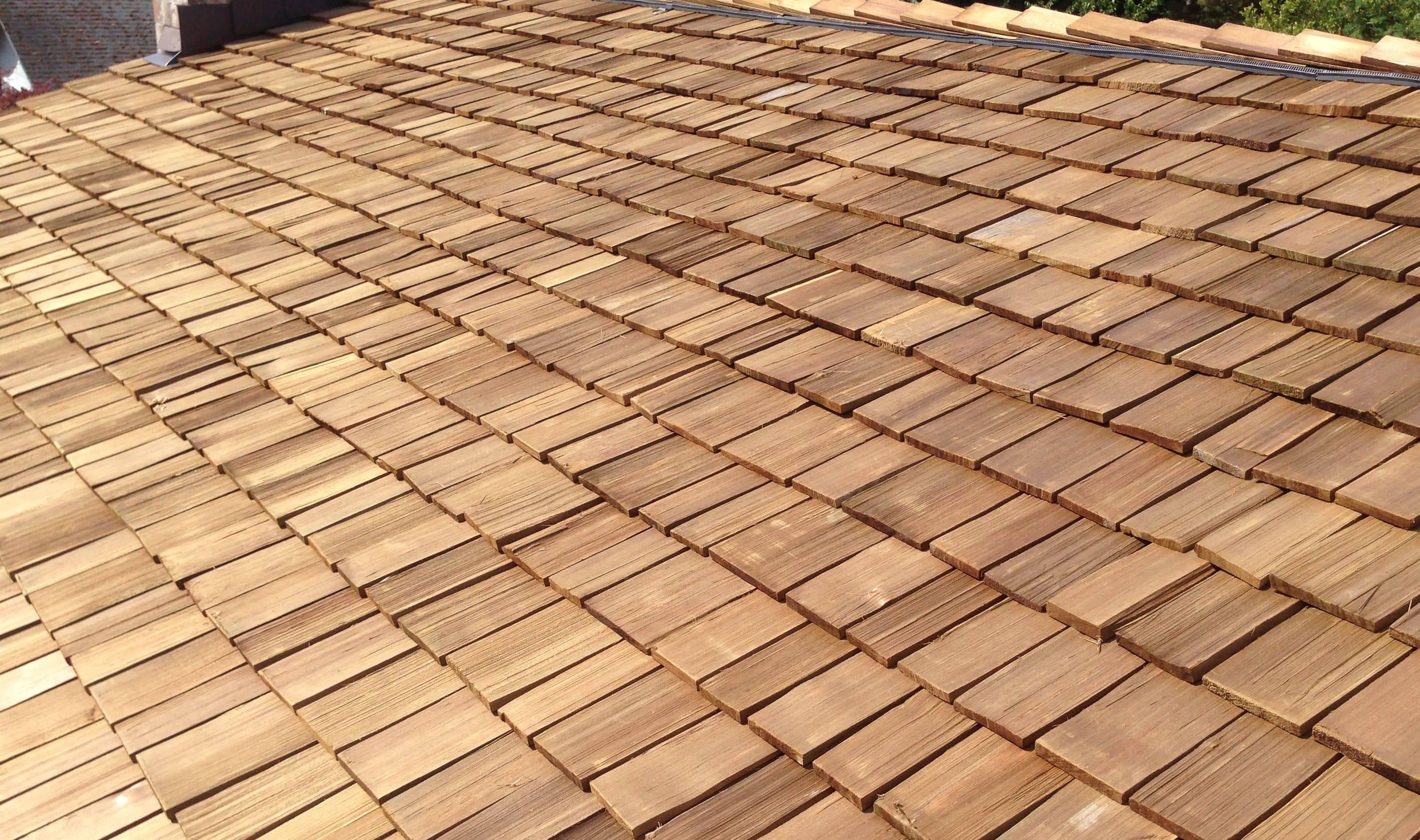 Close-up of cedar shake roofing installed in overlapping rows.