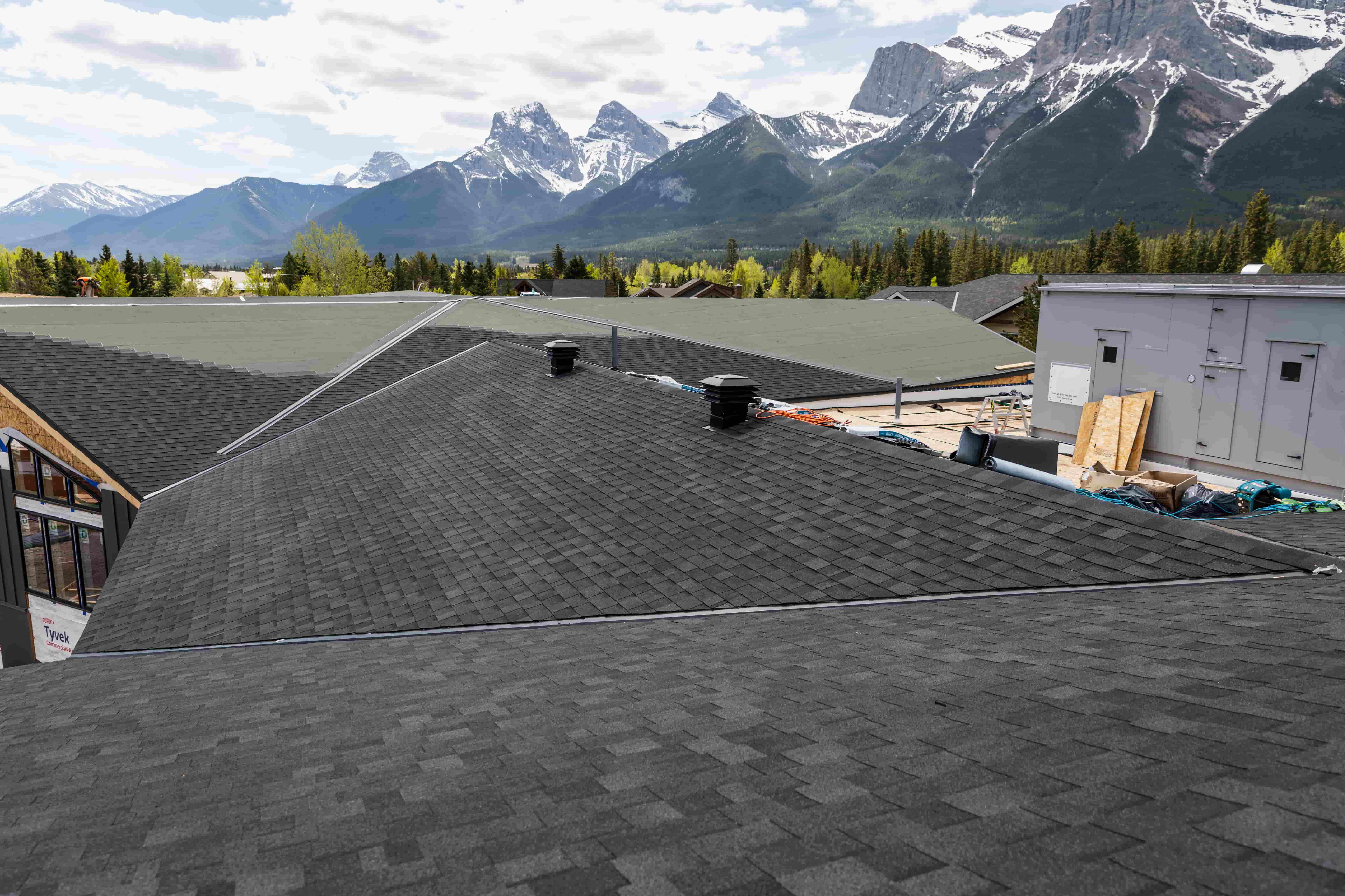 Dark asphalt shingle roof on a building under construction.