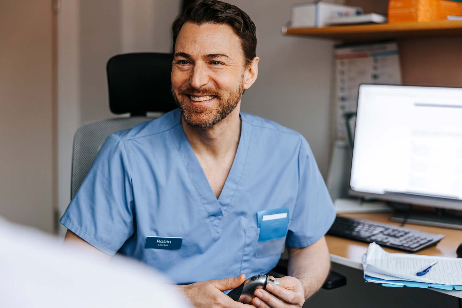 Doctor in blue scrubs consulting with a patient
