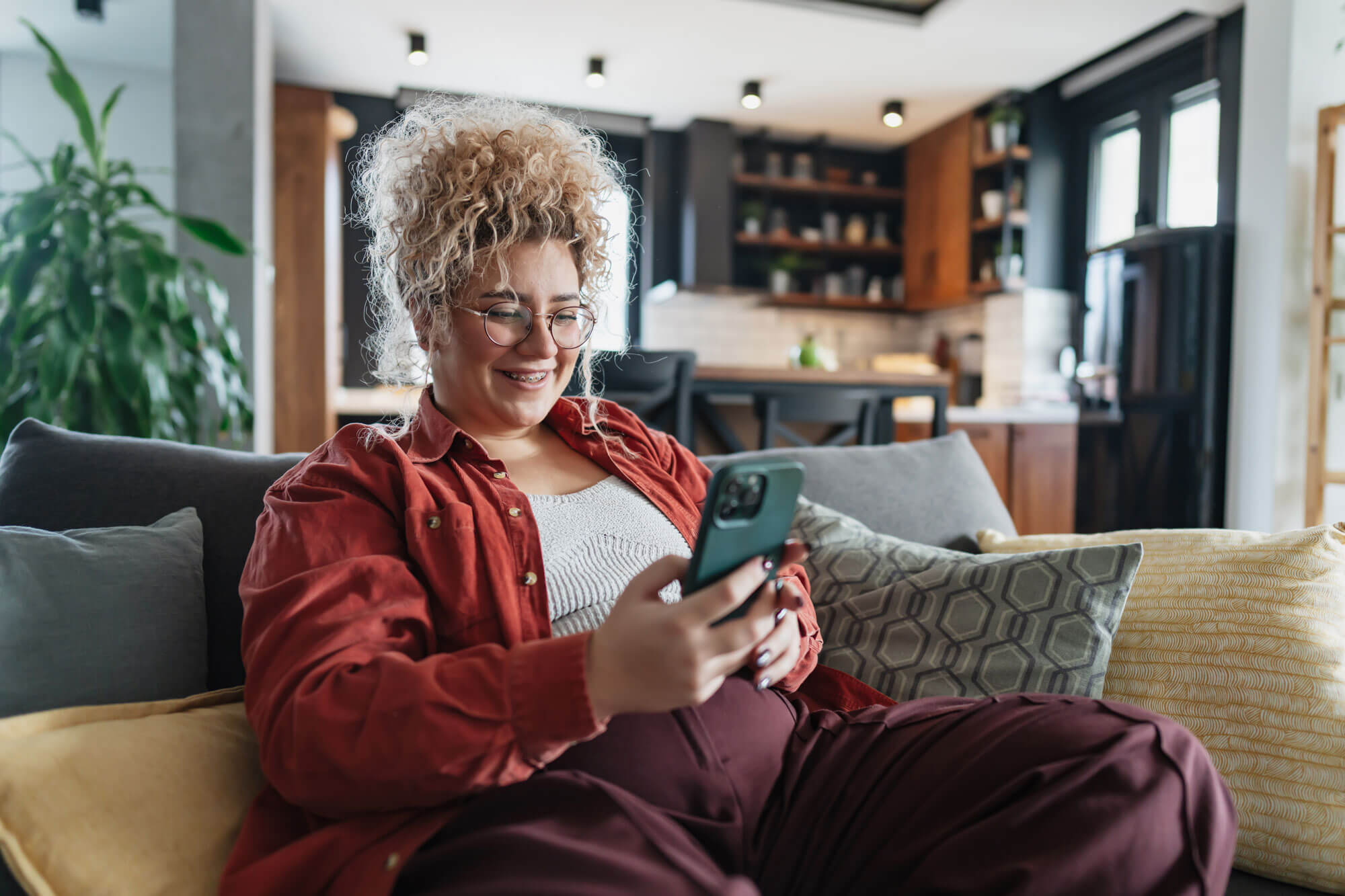 A woman on the couch using her phone