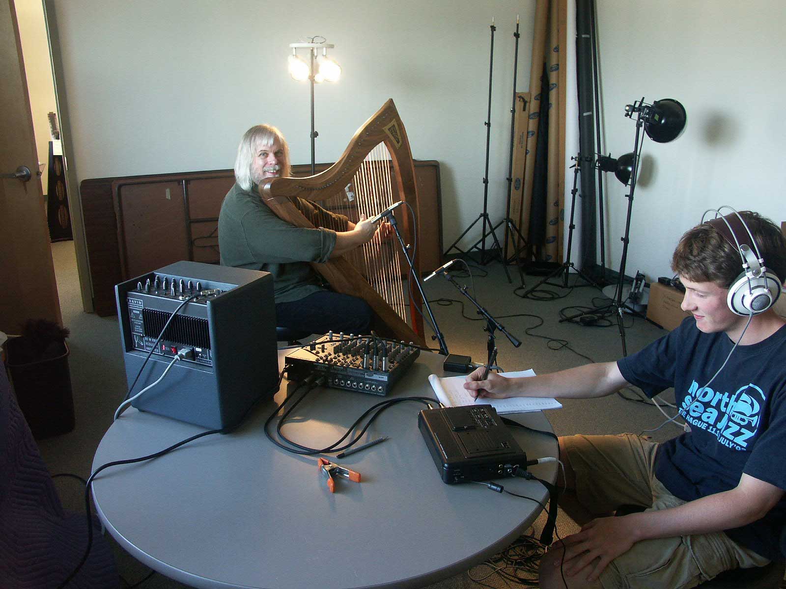 Harpist Harper Tasche poses while playing a Dusty Strings 36-string harp during a recording project.
