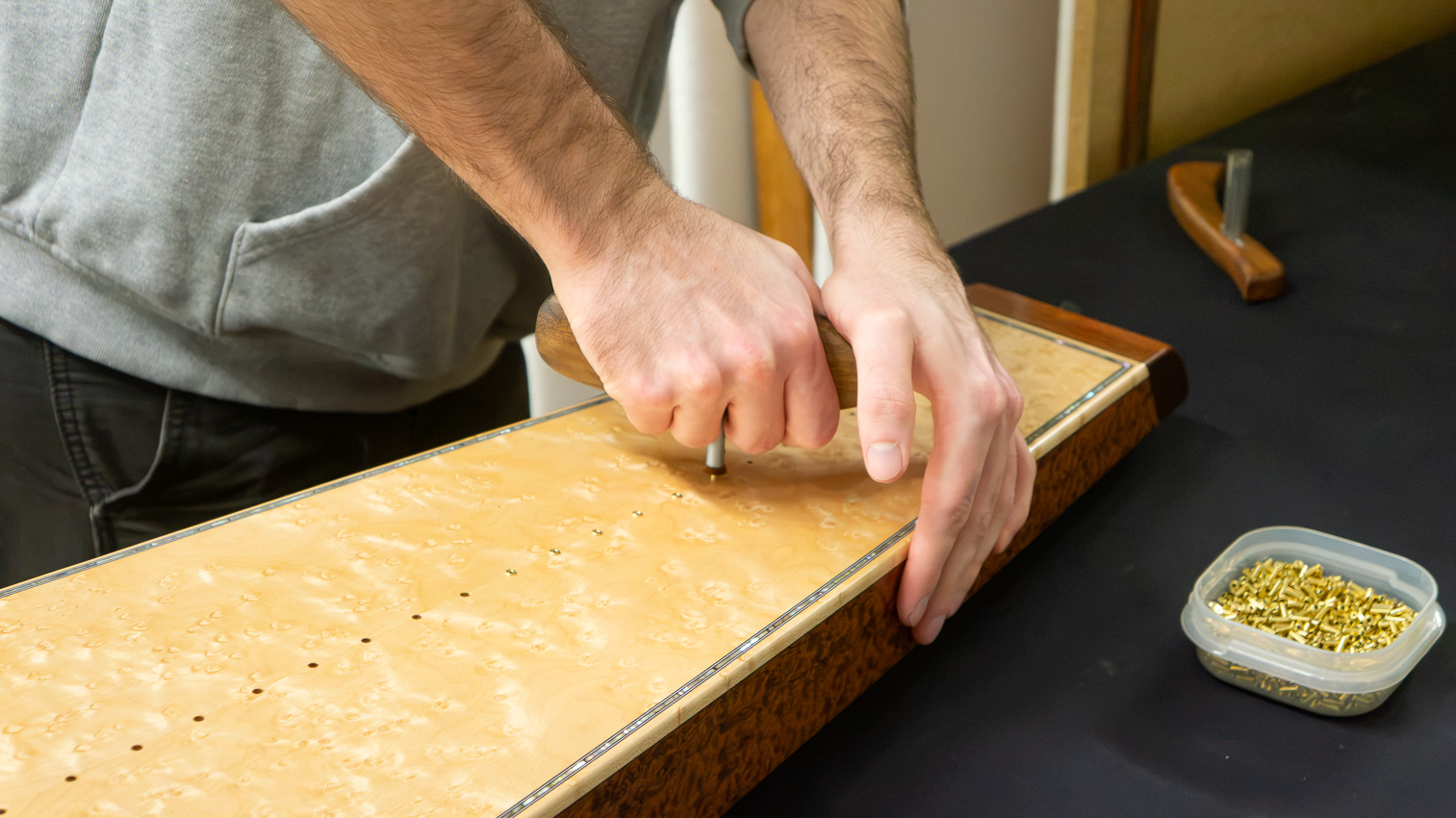 Pressing in the soundboard eyelets