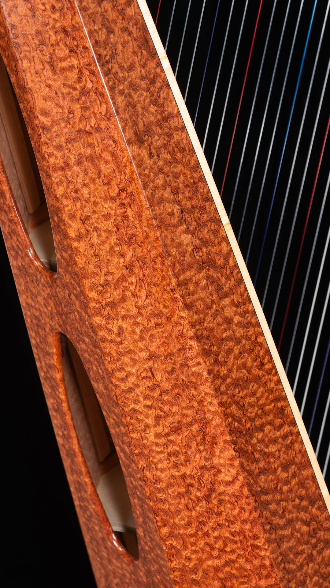 Close-up of the soundbox showing the dense curly figuration of the waterfall bubingahe