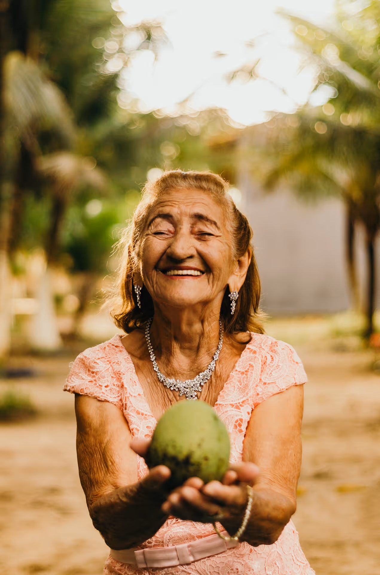 Elderly woman offering fruit