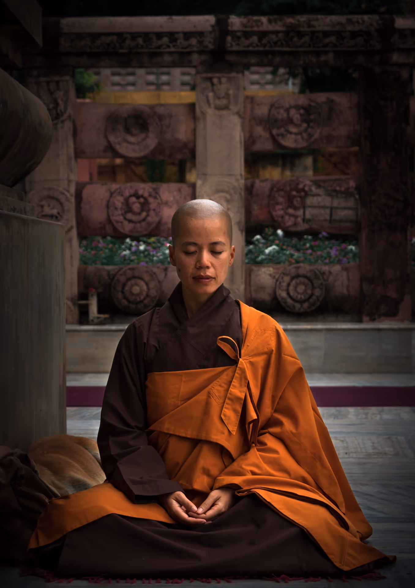 Buddhist nun meditating against a temple backdrop