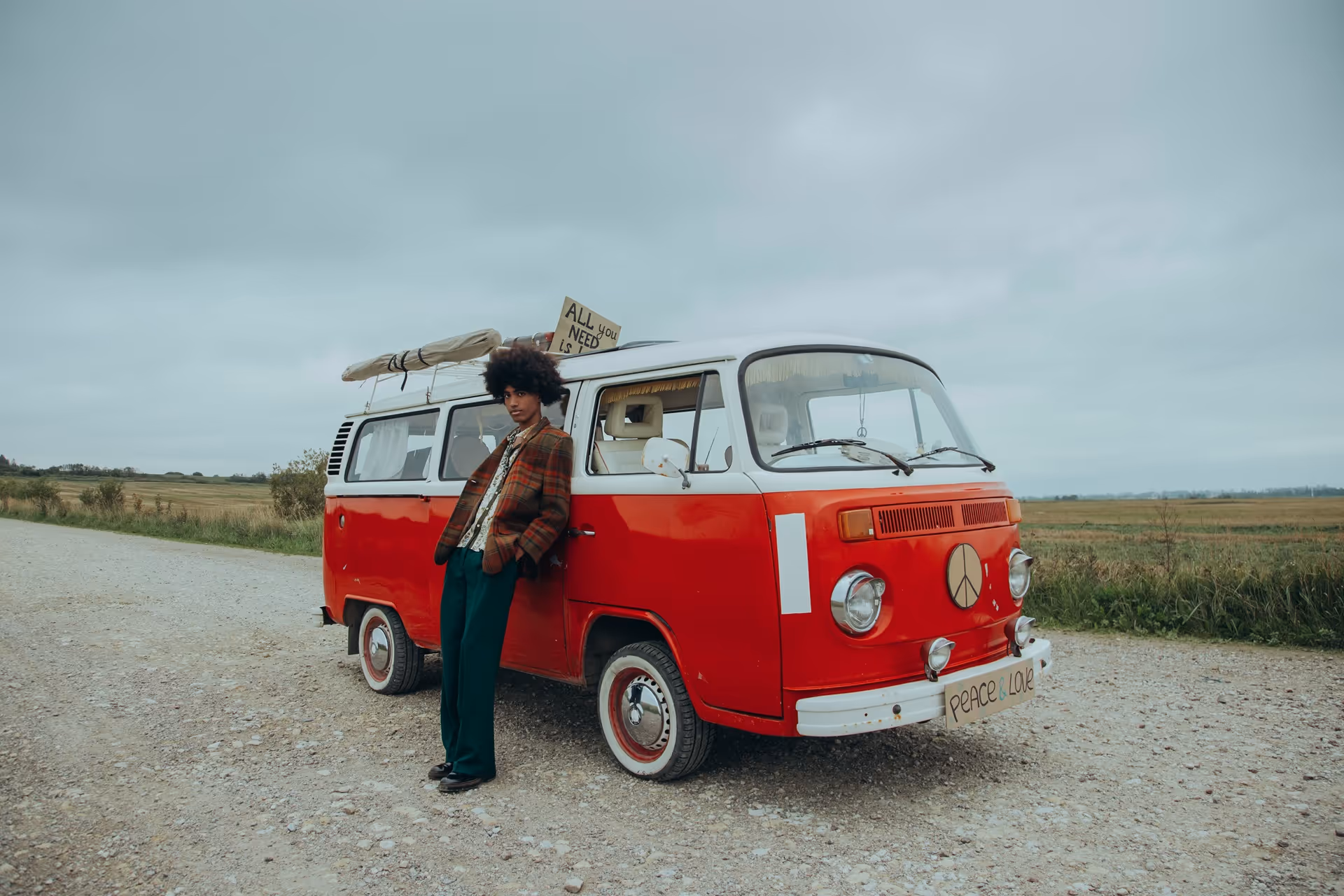 Volkswagen hippie bus with man sporting an Afro hairstyle