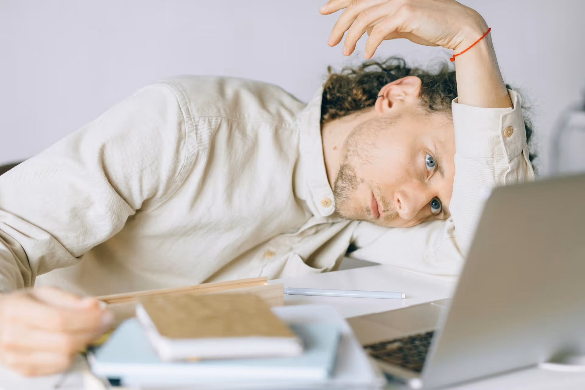 exhausted man in front of his laptop