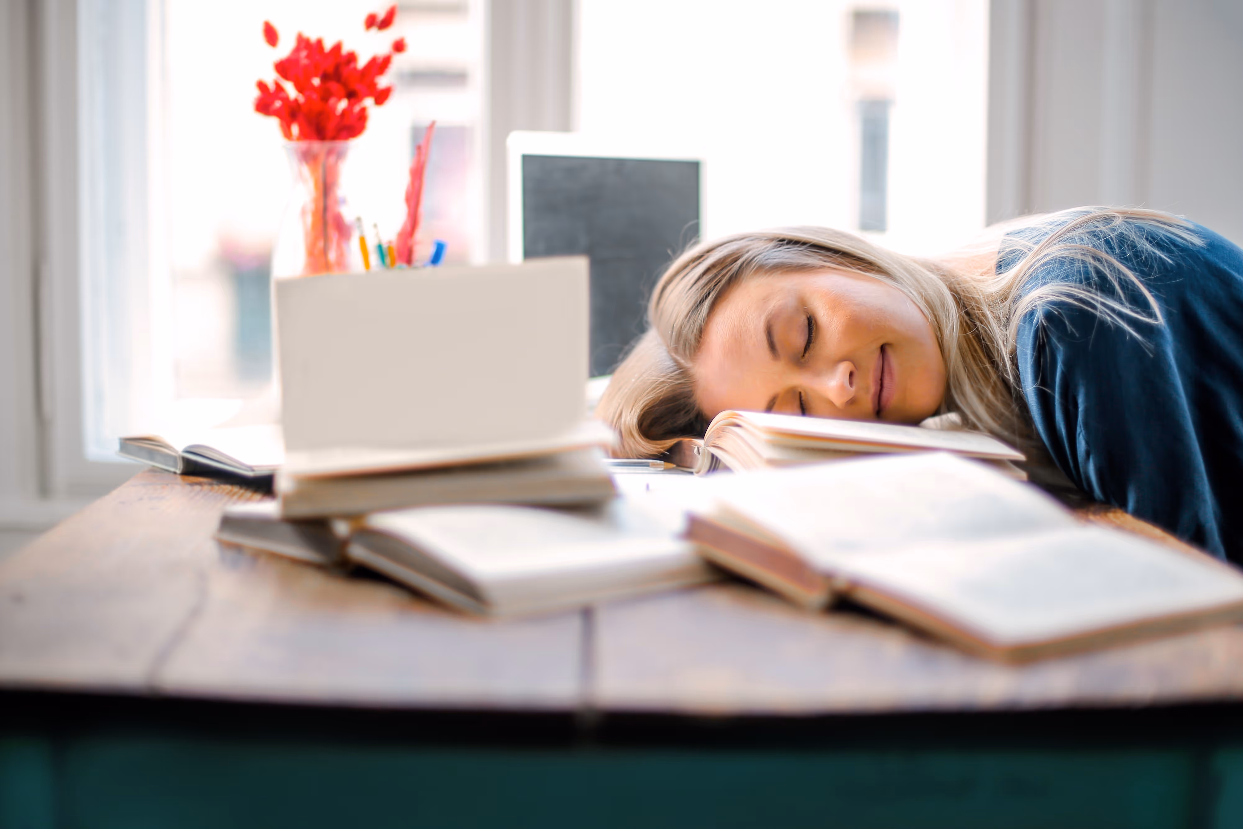 young woman asleep on her desk