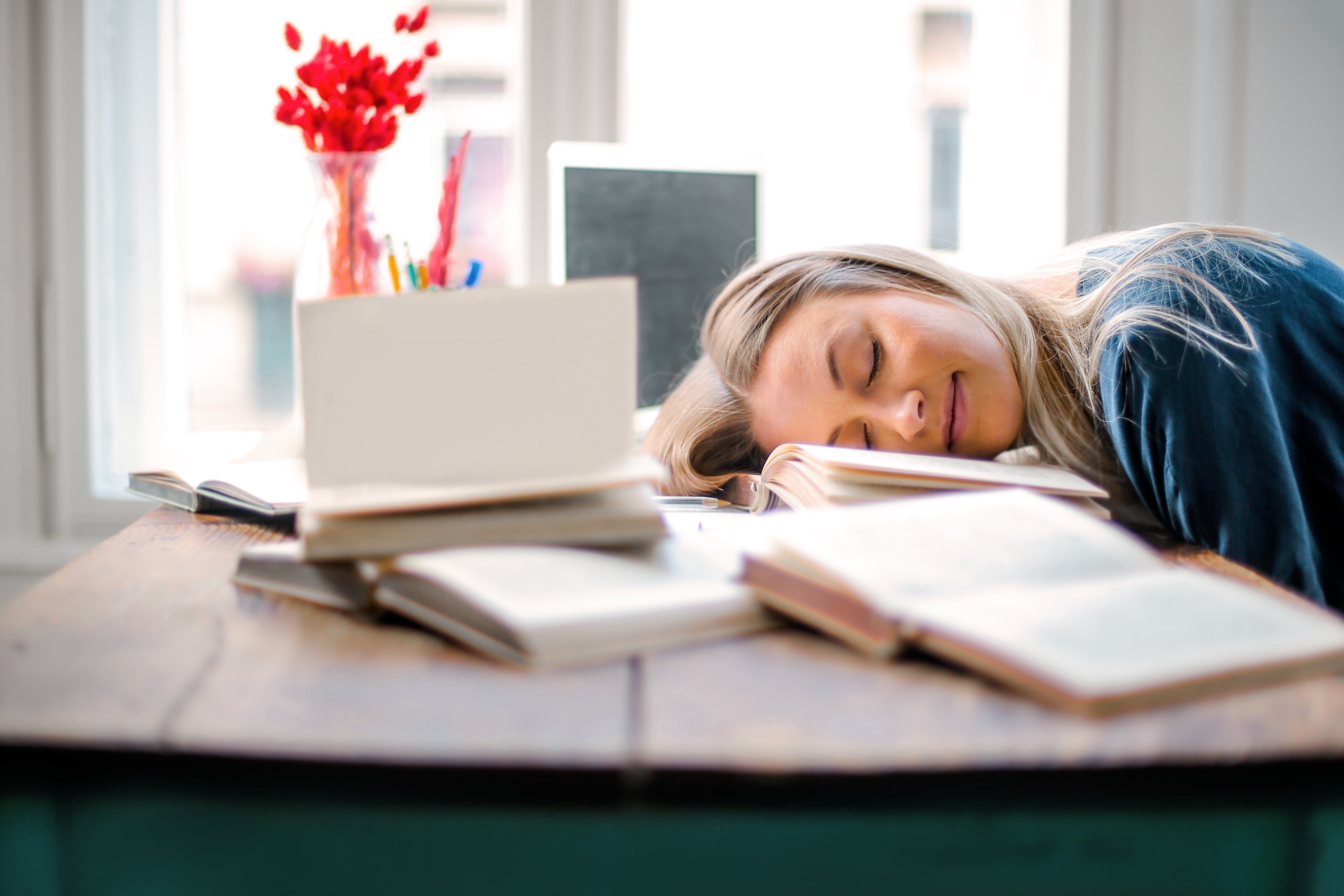 young woman asleep on her desk