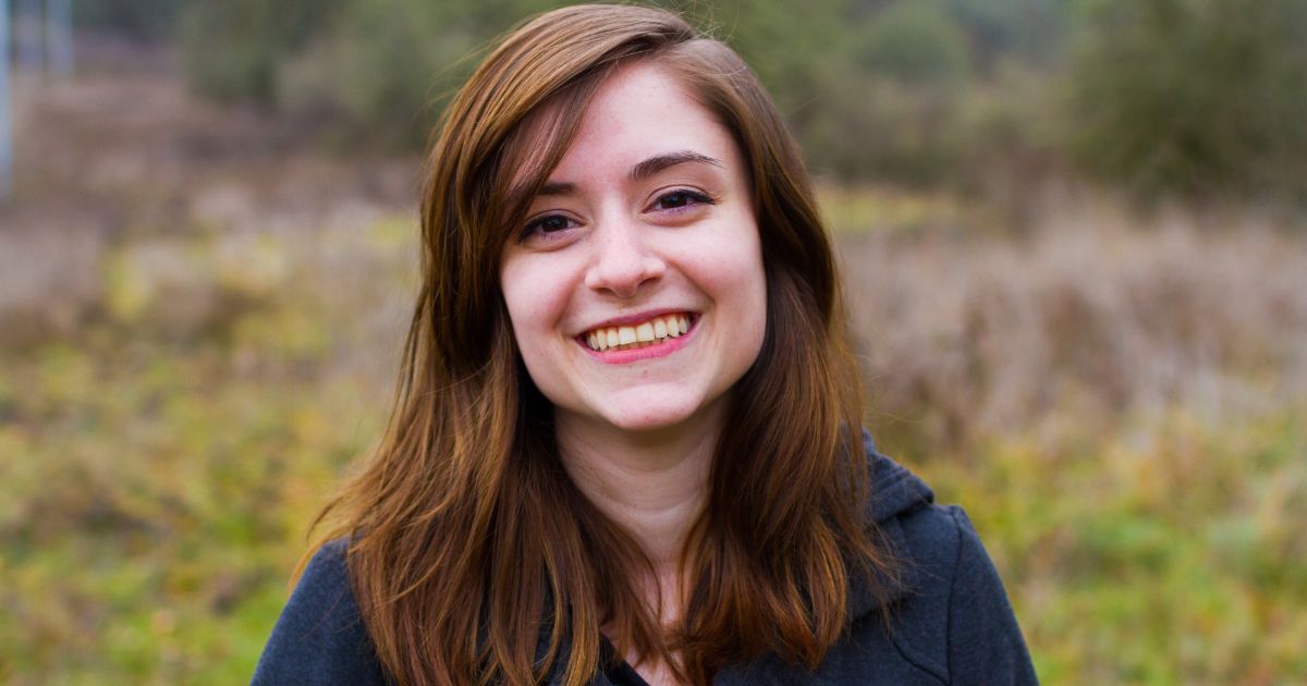 Teenage girl looking happy and smiling in a feild