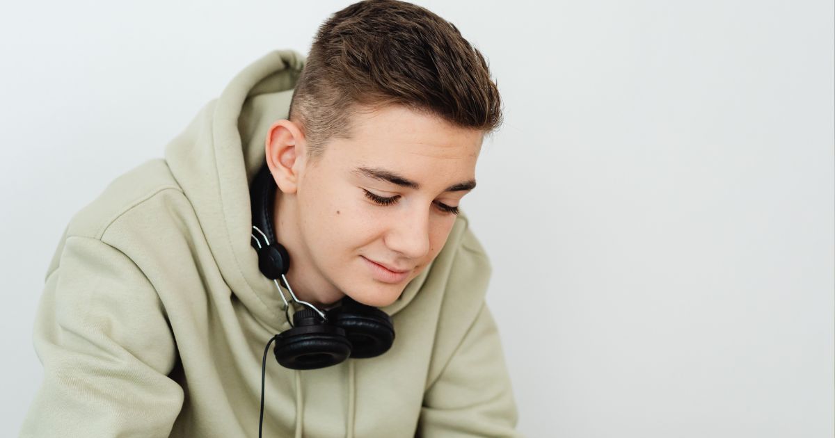 Young teenage boy with headphones on