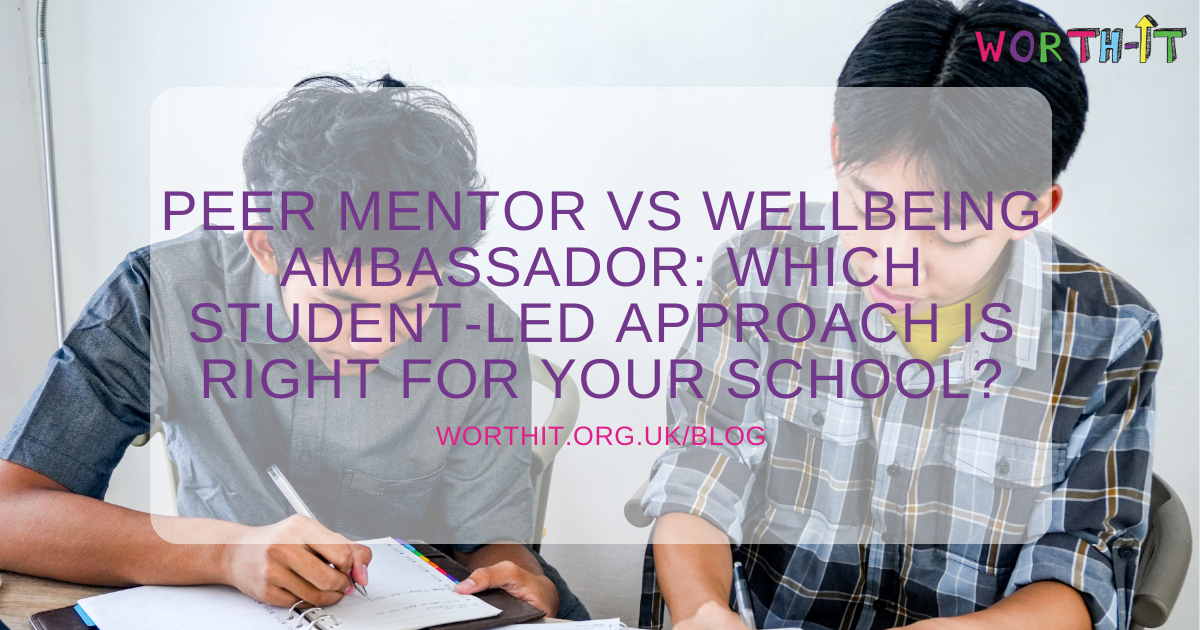 two teenage school boys who are peer mentors writing notes