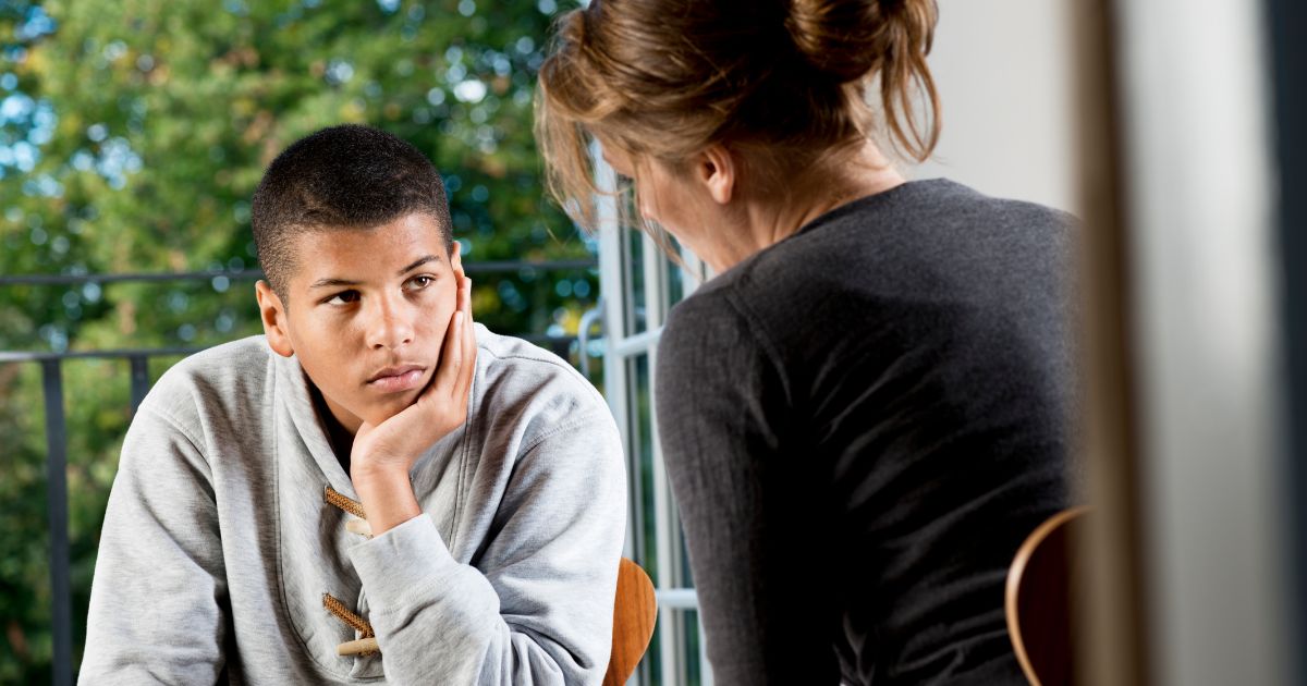 Male student being coached by teacher 
