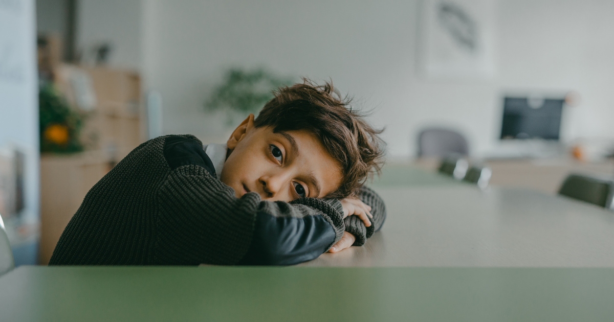 lonely child alone in a classroom showing lack of belonging
