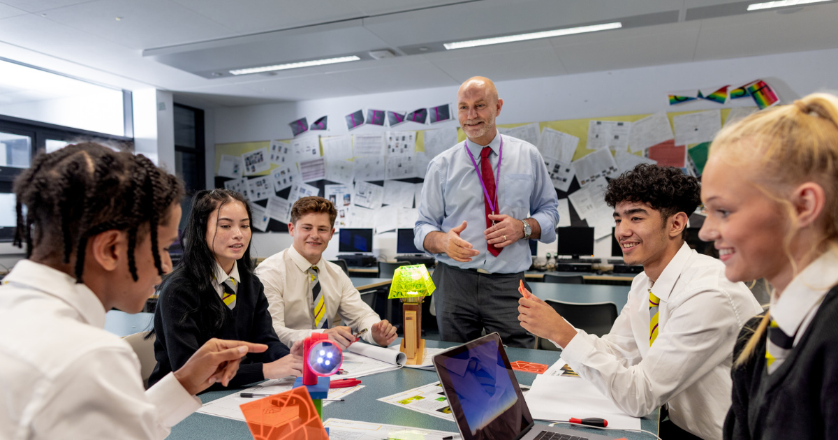 Inclusive group of secondary school aged pupils engaging in a lesson with teacher, showing they belong