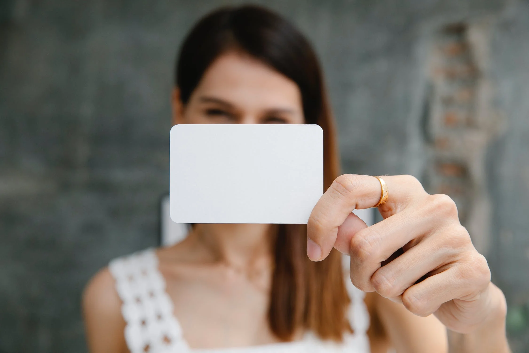 A person holding a blank card 