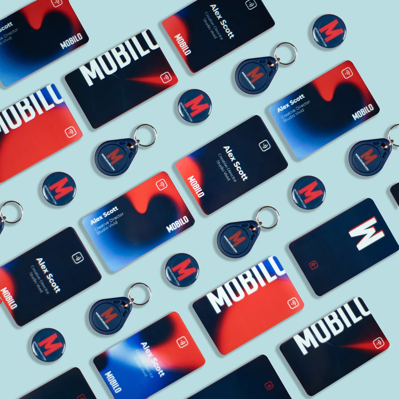 A set of Mobilo NFC Business card and NFC key fob and NFC smart button organized in a diagonal fashion on a flat surface with vibrant background.