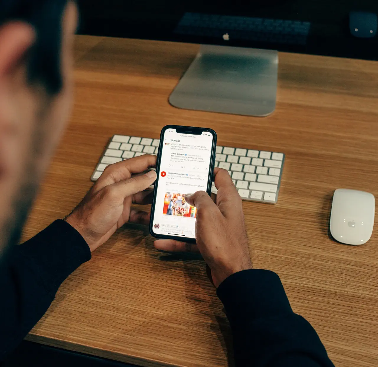 A person holding a phone, screen showing some text