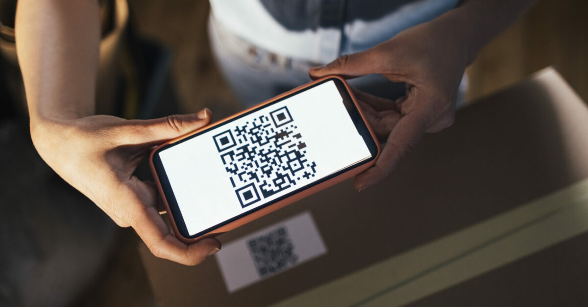 woman holding a qr code - Uniqode Reviews