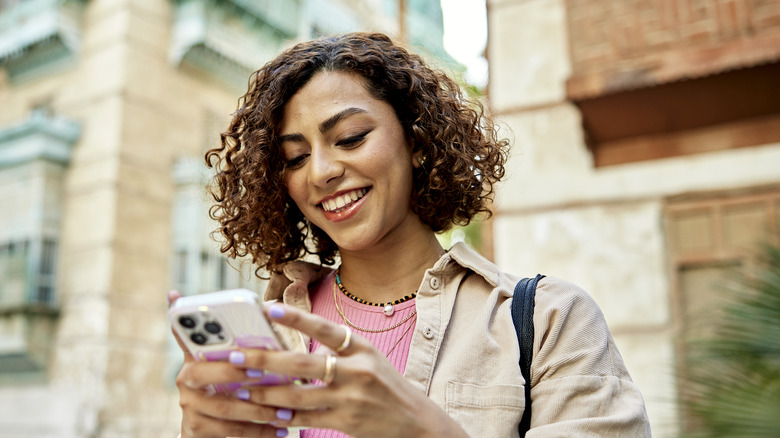 woman smiling - How to Share Contact Card on iPhone