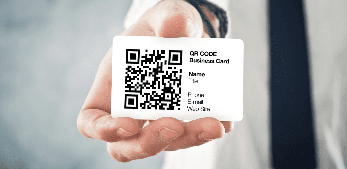 Hand holding a card displaying QR code - QR Code Instead of Business