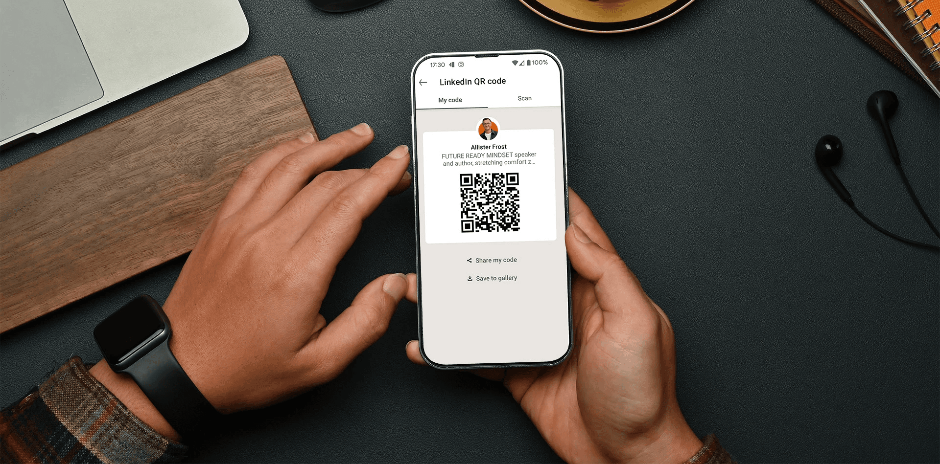 Person holding phone displaying QR code - How to Share LinkedIn QR 