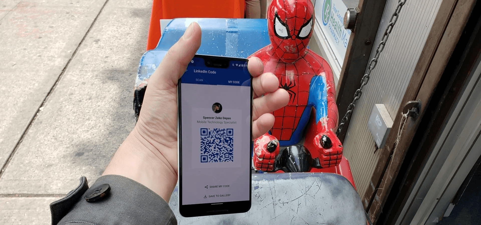 Man showing QR code on his phone - How to Share LinkedIn QR 