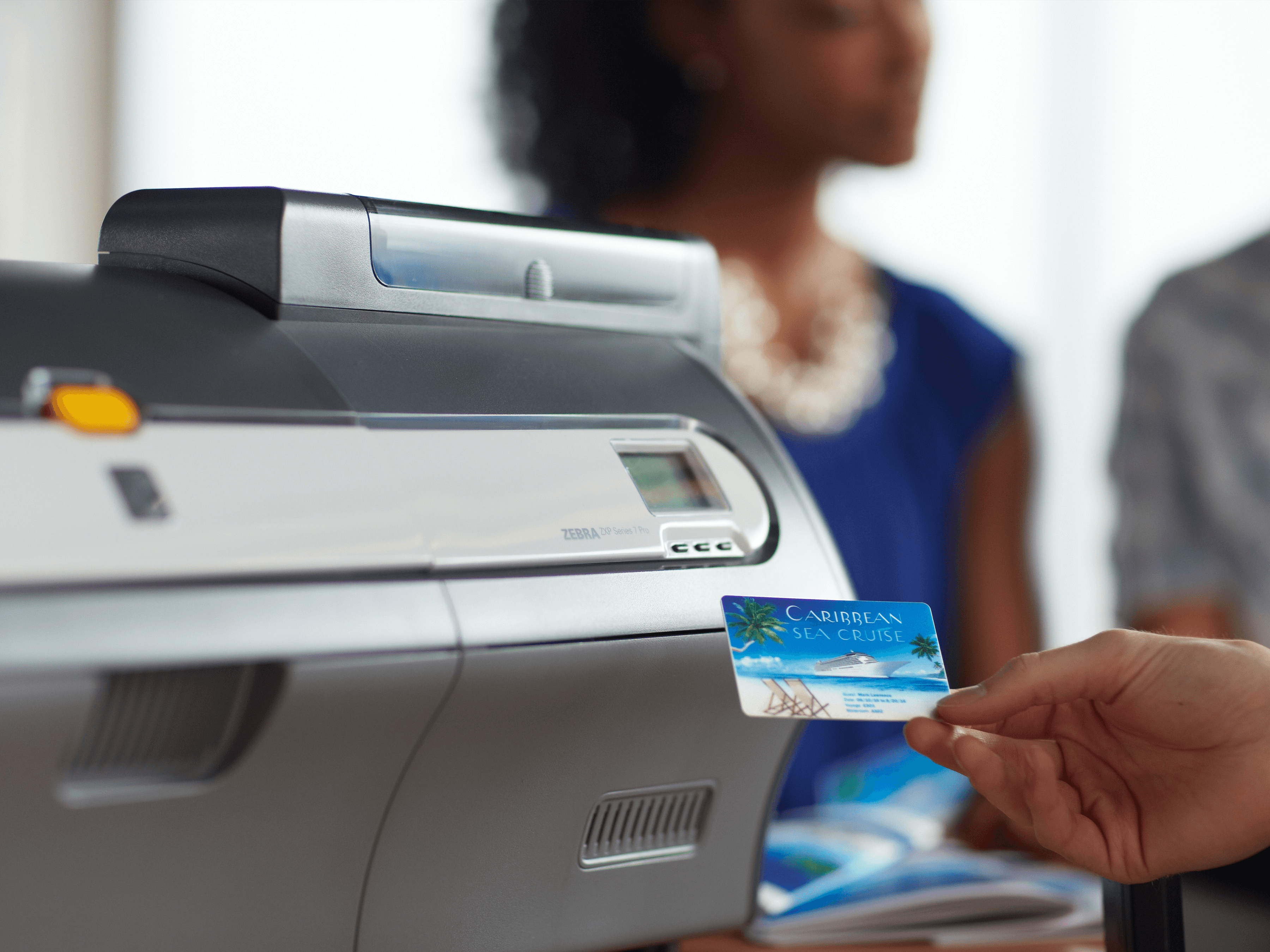 Person holding card near ID printer -  best business card scanners