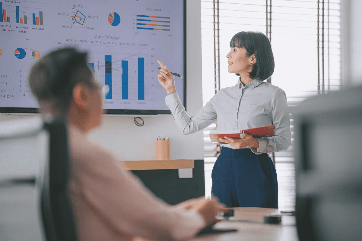 Woman presenting charts during business meeting - Trade Show Lead Capture App