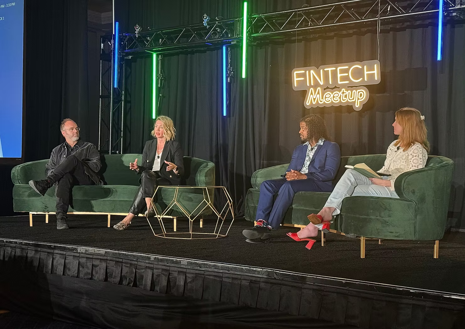 Evan Leaphart on a panel at Fintech Meetup, seated on stage with three other panelists