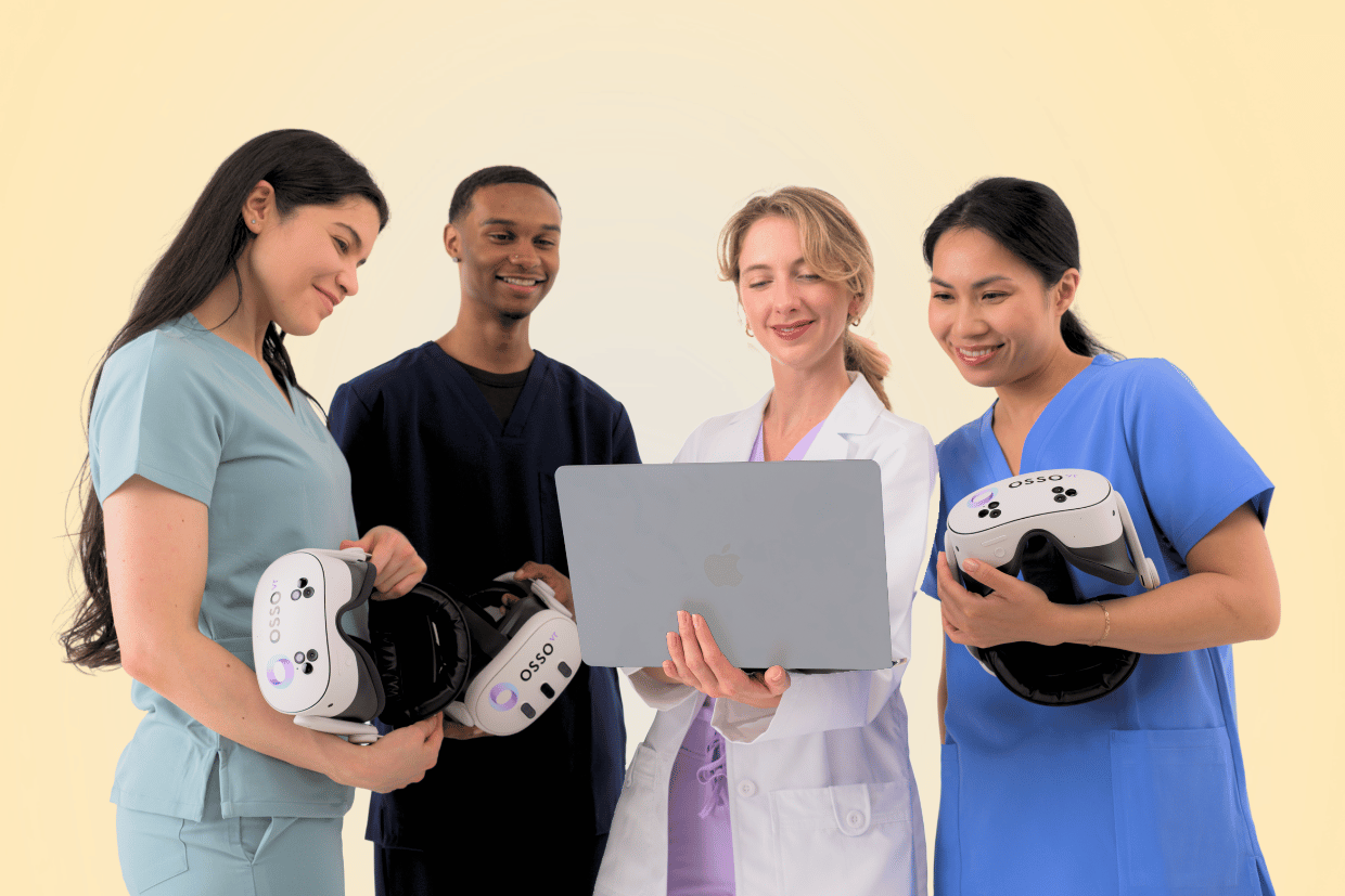 Four healthcare professionals standing against a light background, one in a white coat holding a laptop while the others in scrubs hold VR headsets labeled OSSO VR, smiling and engaged.