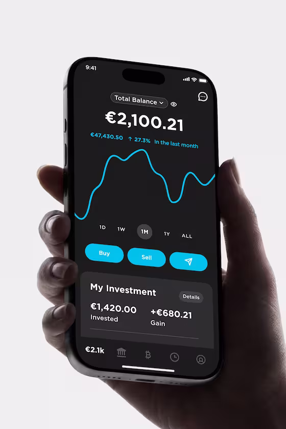 A hand holding a smartphone with the 21bitcoin app displays the total value, monthly growth, and “Buy” and “Sell” buttons.