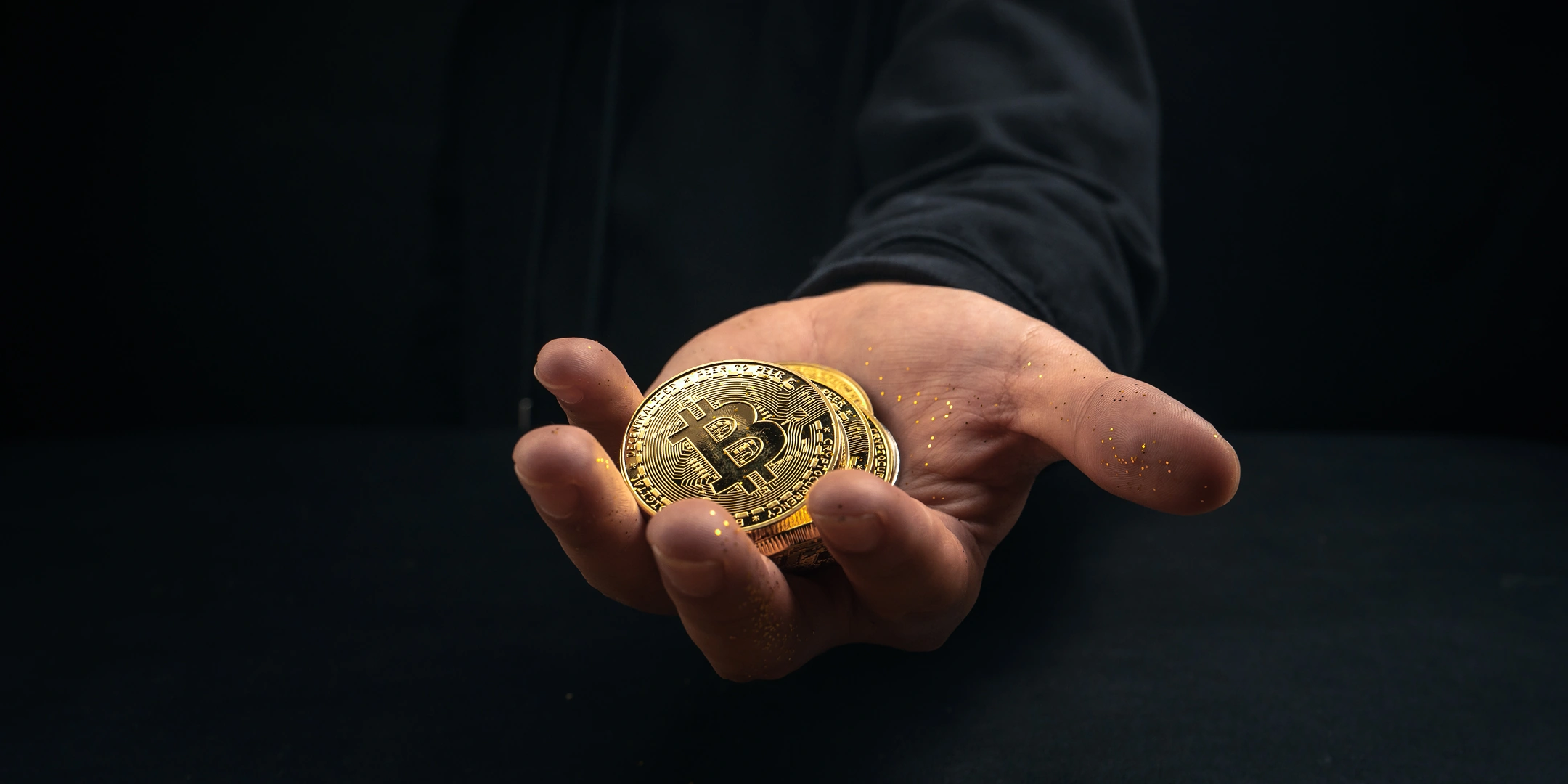 Hand gives a bitcoin