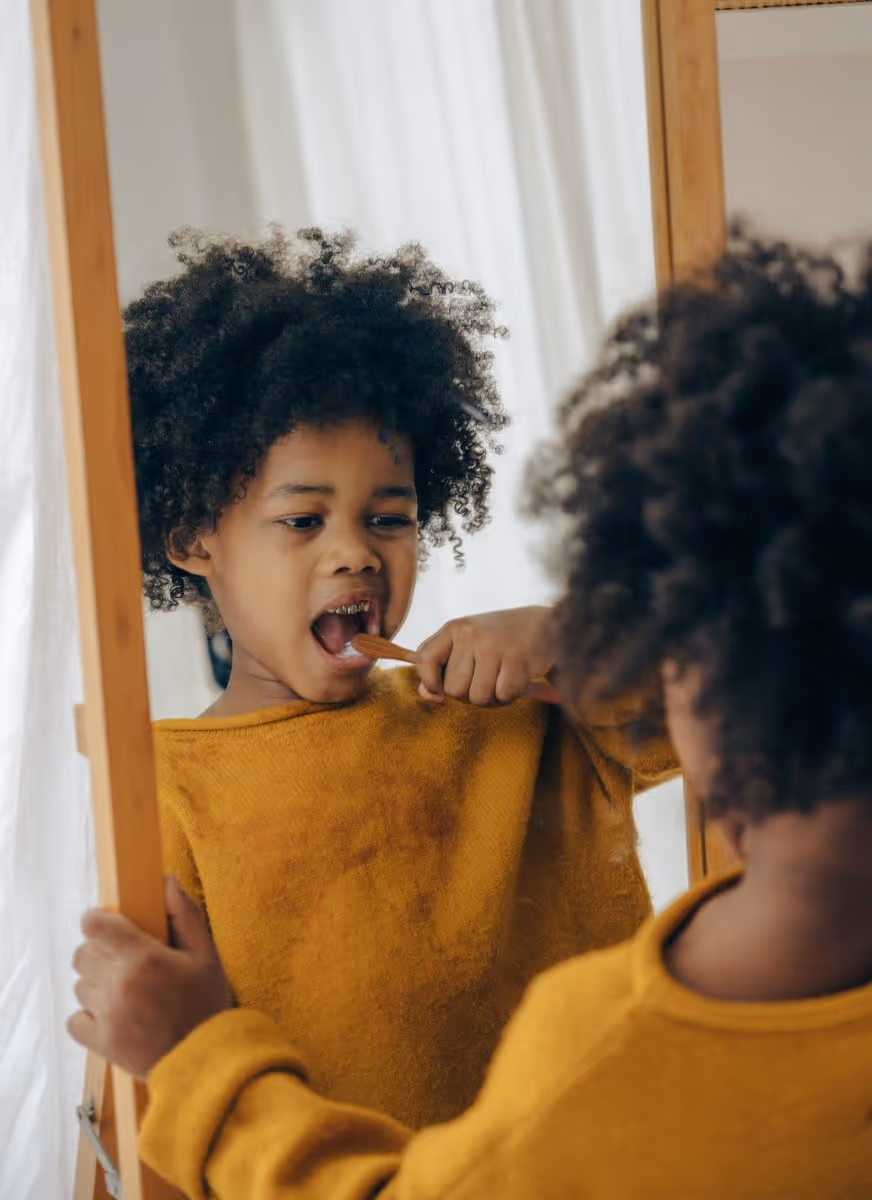 little girl brushing her teeth