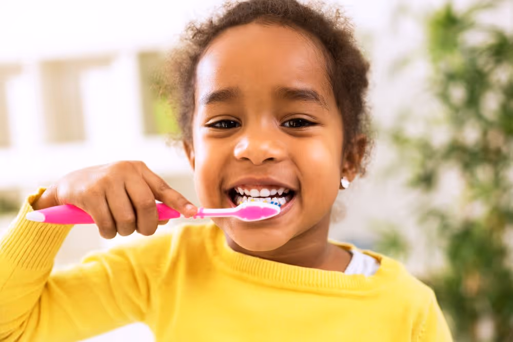 little girl brushing her teeth