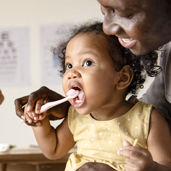 baby holding tooth brush