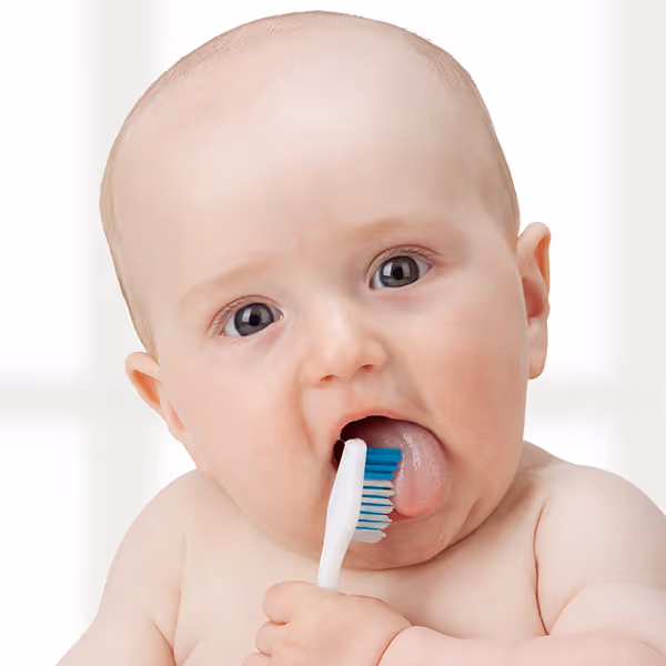 baby holding tooth brush