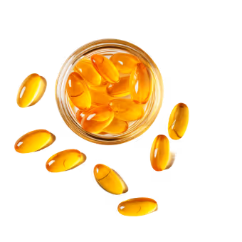 A jar filled with yellow pills on top of a table.