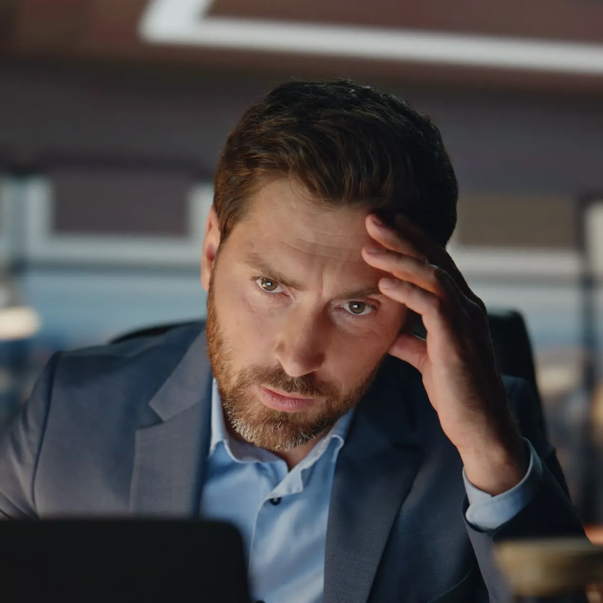 A man sitting in front of a laptop computer.