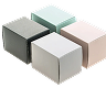 Four small square paper boxes in different muted colors arranged in a cluster on a white background.