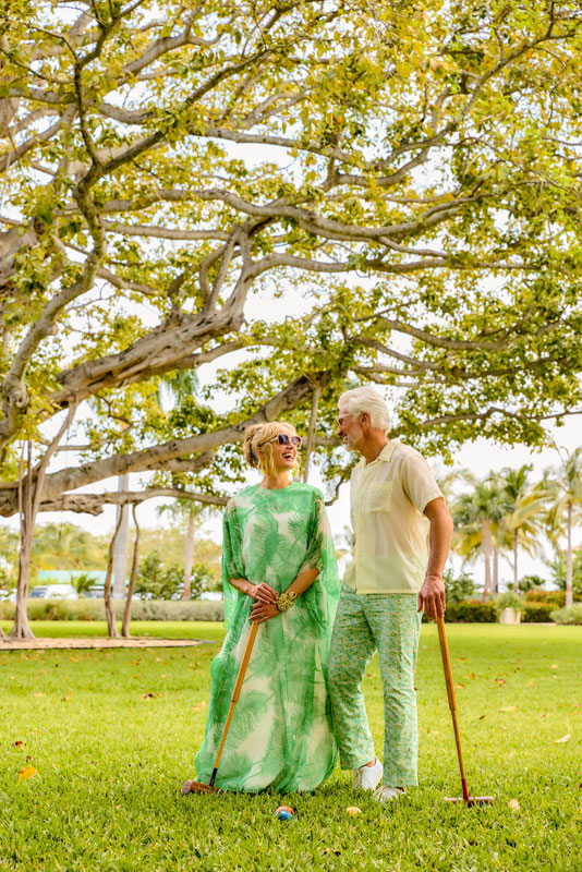 Couple playing croquet at Lake Drive Park, adjacent to the Marina.