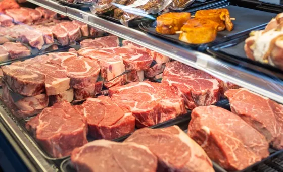 Fresh cut Dakota Butcher steaks behind glass