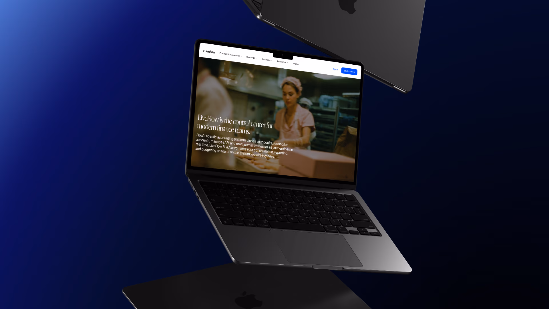 Floating MacBook laptop open to a finance platform website featuring a woman in a kitchen background.