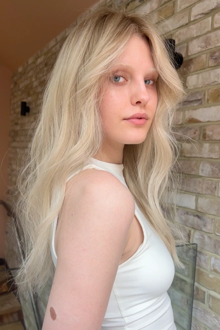Young woman with long, wavy blonde hair at Bond hair salon