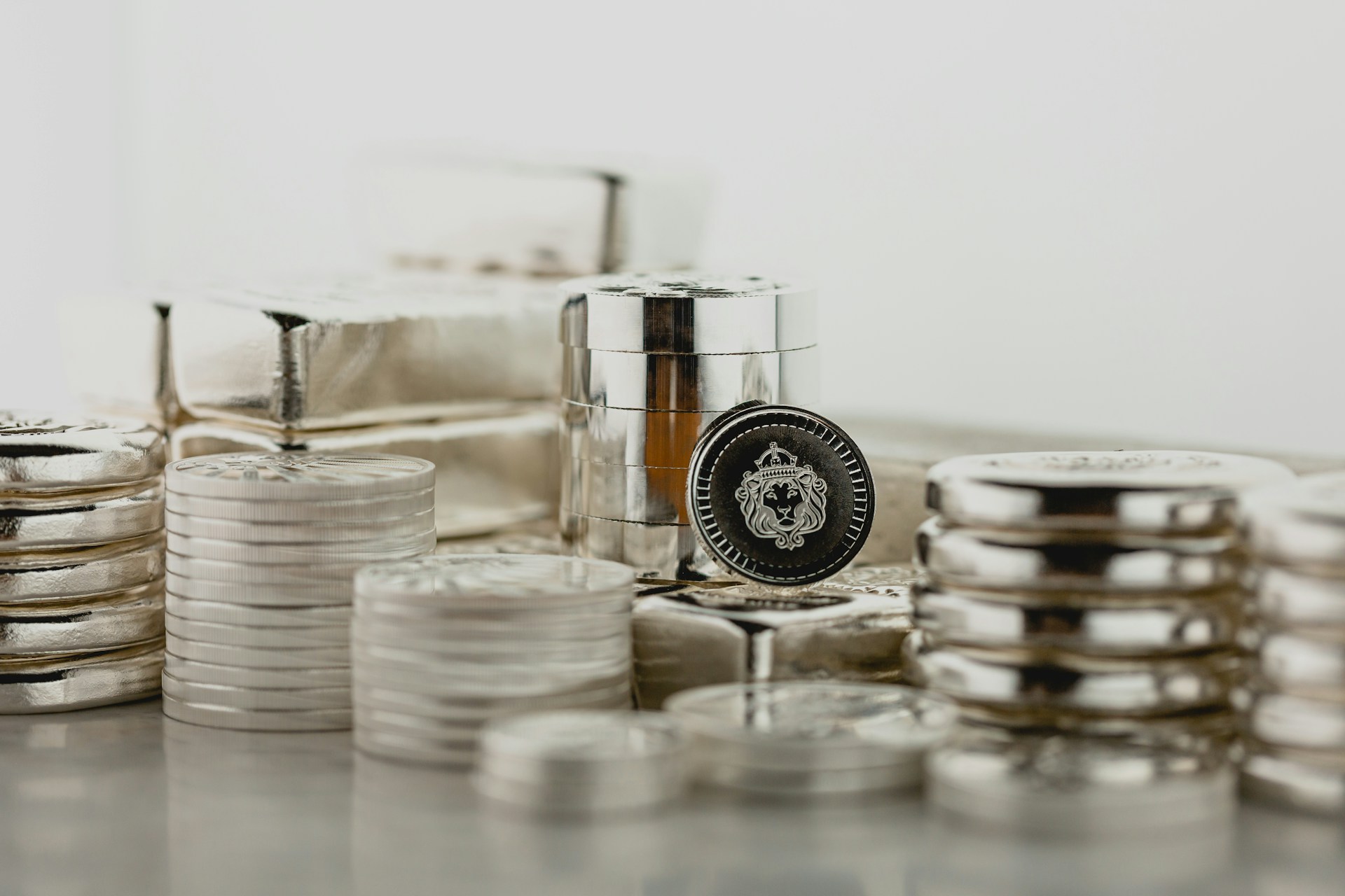 Stacks of platinum and silver bars and coins