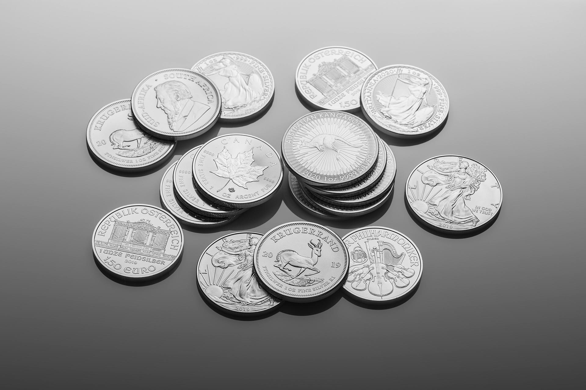 silver coins in a pile against a gray background