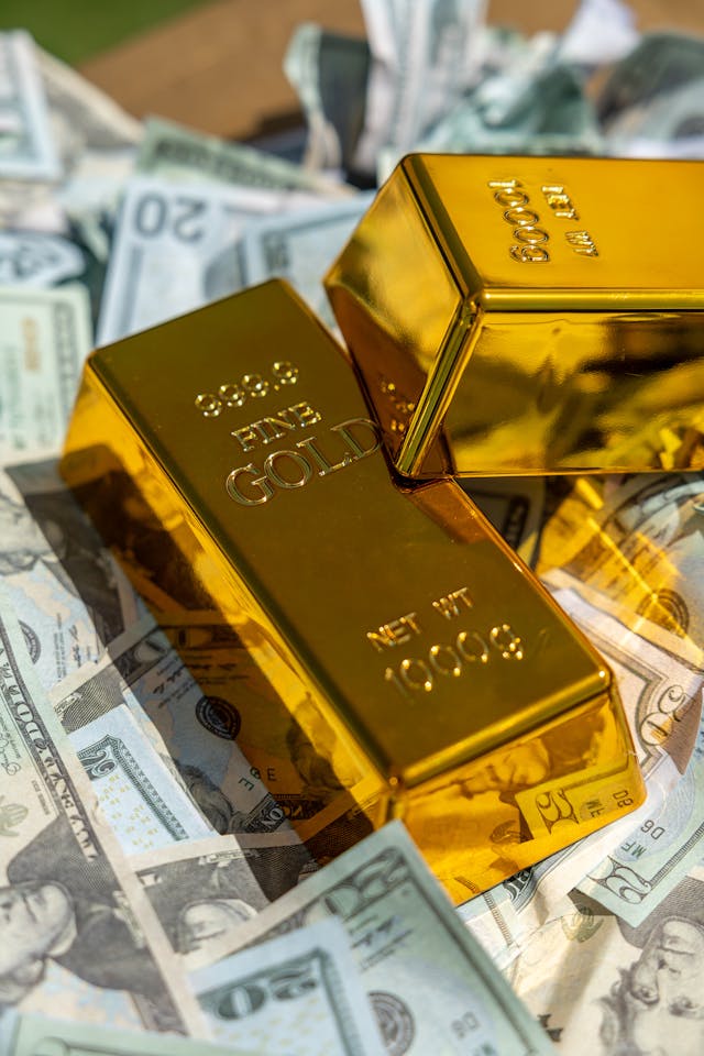 a gold bar with USD 20 dollar bills around it
