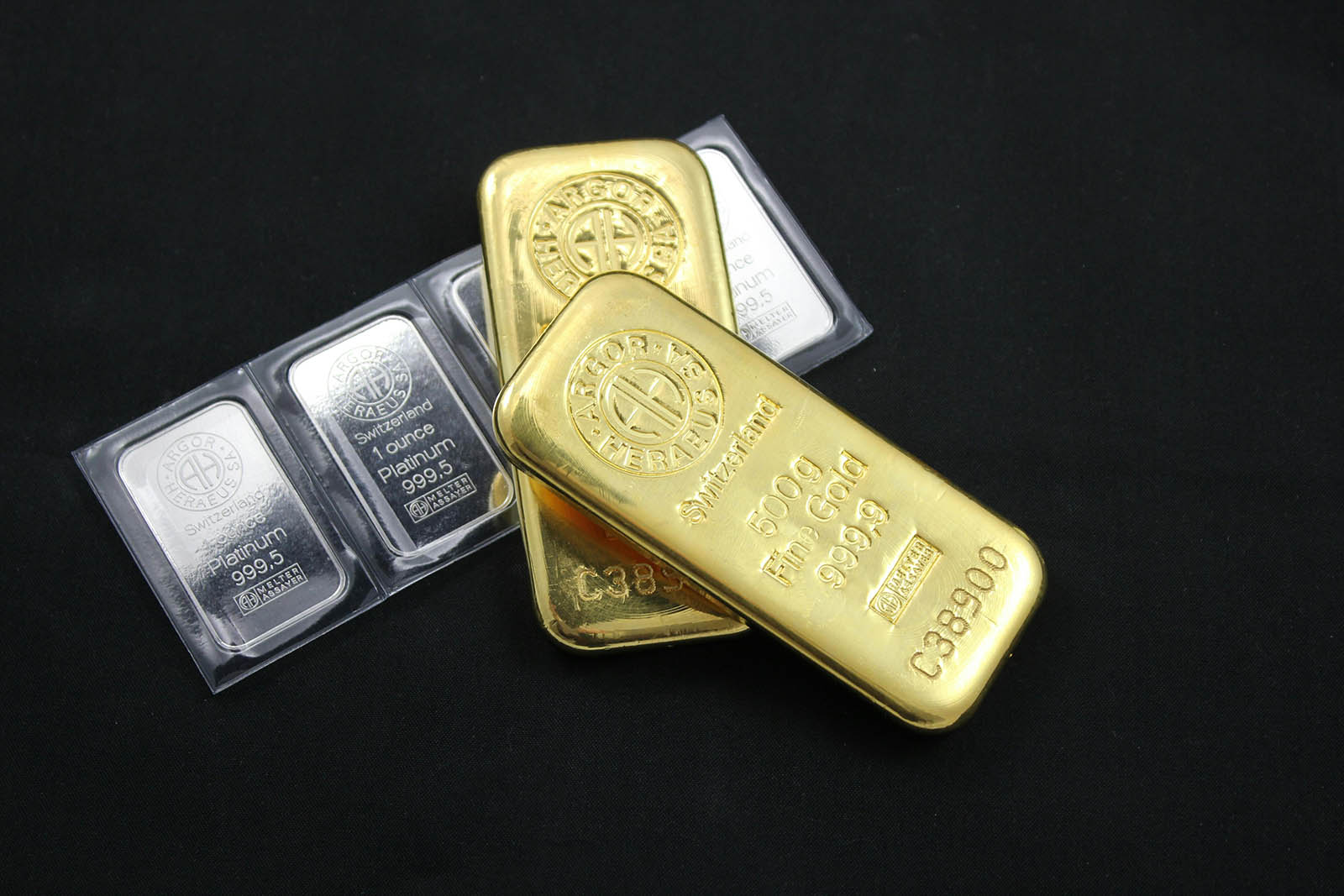 silver and gold bars against a black background